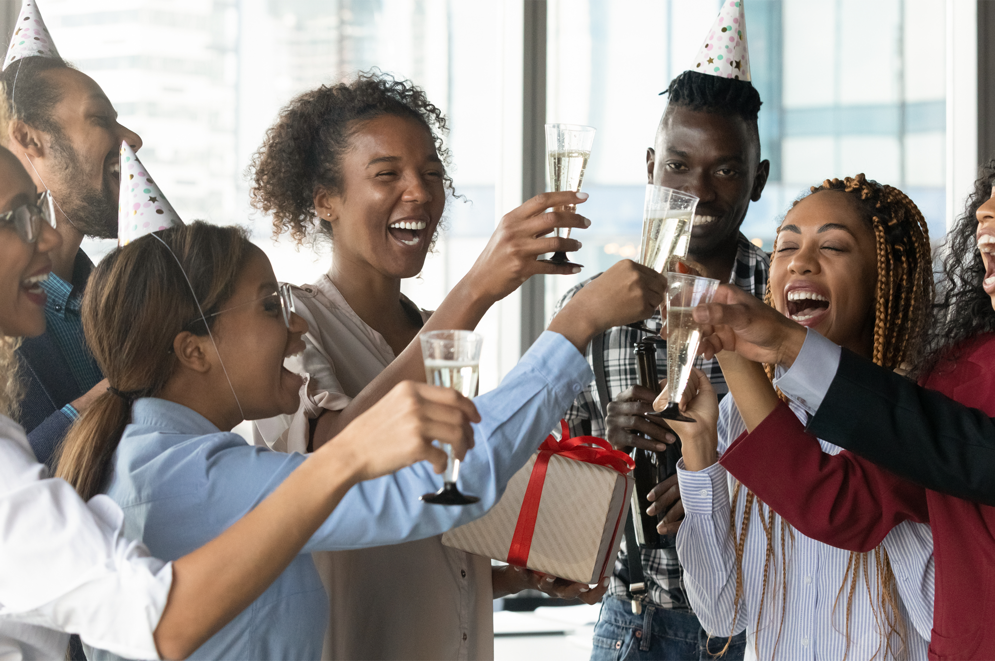 A group of people celebrating in the office.